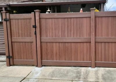 6-foot embossed wood grain vinyl fence with middle rail.