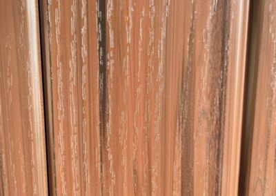 Close up of a sequoia embossed wood grain vinyl fence panel